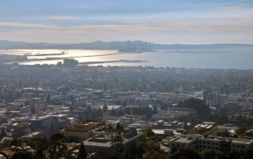 An aerial photo of the East Bay (foreground) and San Francisco (background) area. A new study details how historical redlining has influenced levels of native and non-native wildlife biodiversity four of California's largest cities. Photo by C. Schell