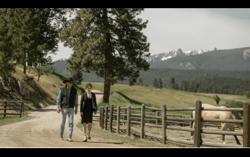 picture from "Yellowstone" 2 people walking on a dirt road